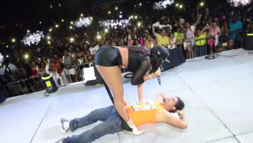Destra standing over Fernando Oliva, a man at one of her concerts who suffered injuries from one of her dance moves.