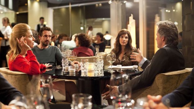 The Dinner cast members at dinner in a restaurant; Steve Coogan and Rebecca Hall, facing camera; Laura Linney (side-view) and Richard Gere with back to the camera.